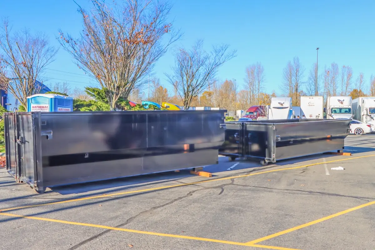 Professional dumpster rental service with roll-off container on residential driveway in Lovejoy